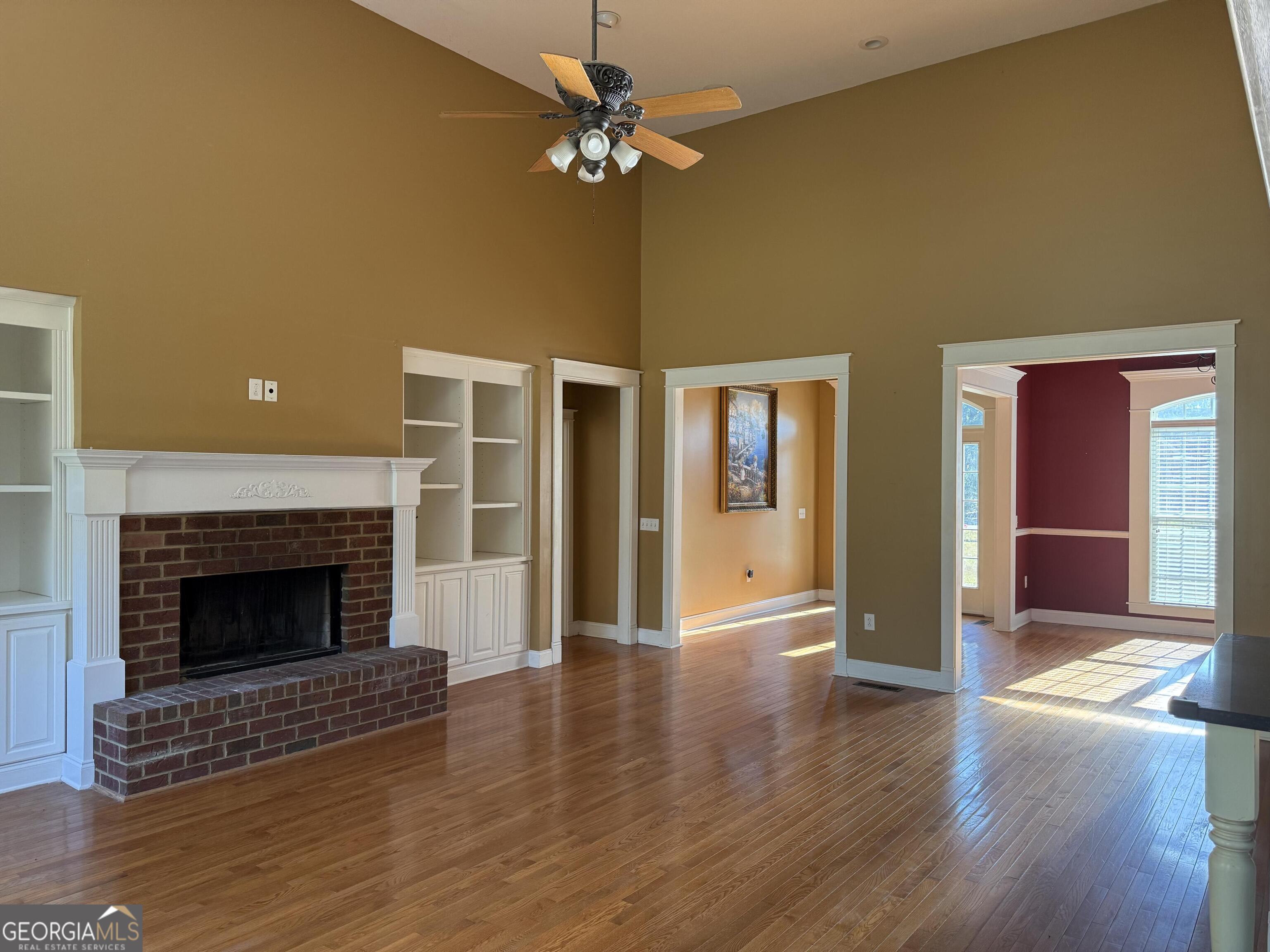713 West Lane Street Brooklet, GA 30415 - Photo 8 of 39 a view of an empty room with glass door and a fireplace