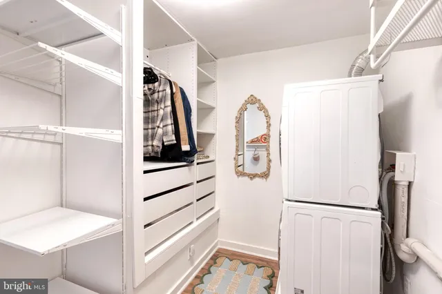 a view of walk in closet with empty racks