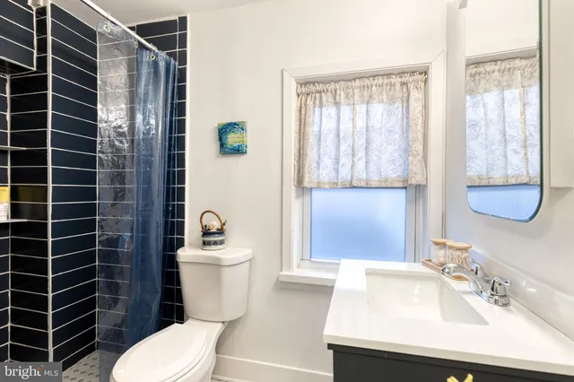 a bathroom with a sink a toilet and mirror