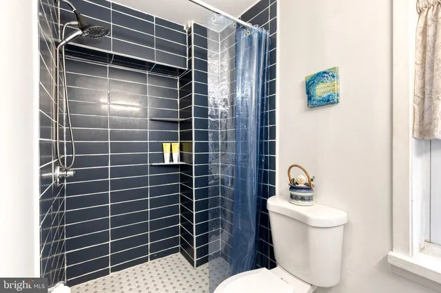 a bathroom with a toilet a sink and a mirror