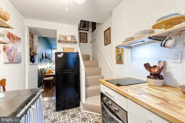 a kitchen with a sink a stove and refrigerator