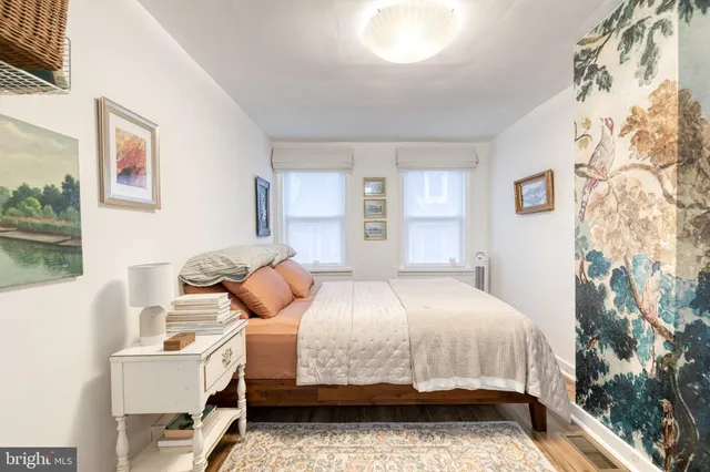 a bedroom with a bed and windows