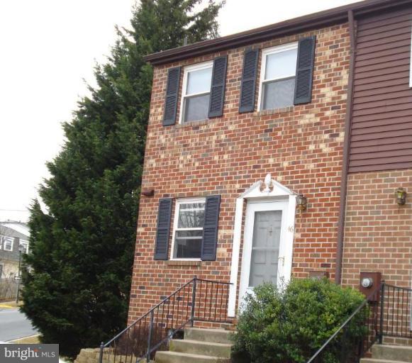 46 Ritters Ridge Court, Unit 46 Owings Mills, MD 21117 - Photo 1 of 8 a brick house with a large windows