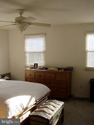 46 Ritters Ridge Court, Unit 46 Owings Mills, MD 21117 - Photo 6 of 8 a bed sitting in a bedroom next to a window