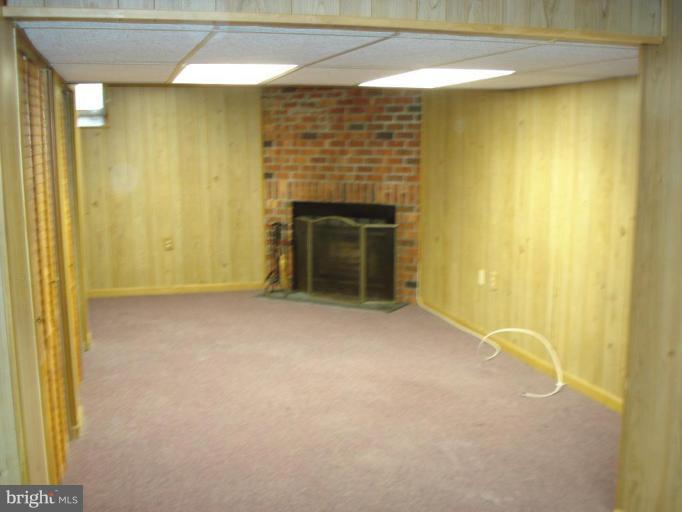 46 Ritters Ridge Court, Unit 46 Owings Mills, MD 21117 - Photo 8 of 8 a view of an empty room with a fireplace