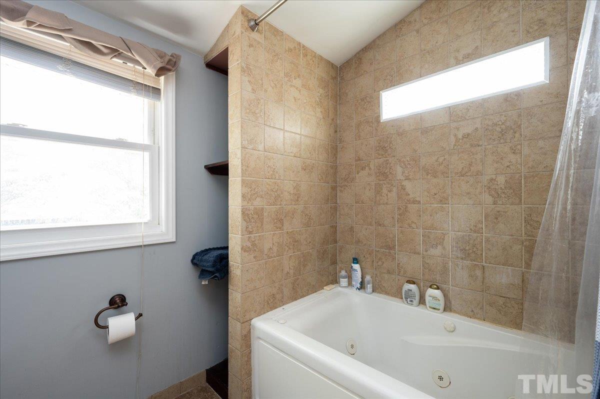 302 Georgetown Road Raleigh, NC 27608 - Photo 12 of 19 a bathroom with a bathtub and shower