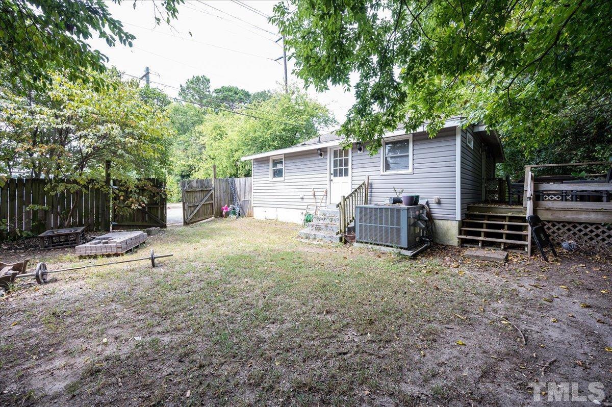 302 Georgetown Road Raleigh, NC 27608 - Photo 17 of 19 a view of a backyard with large trees and wooden fence