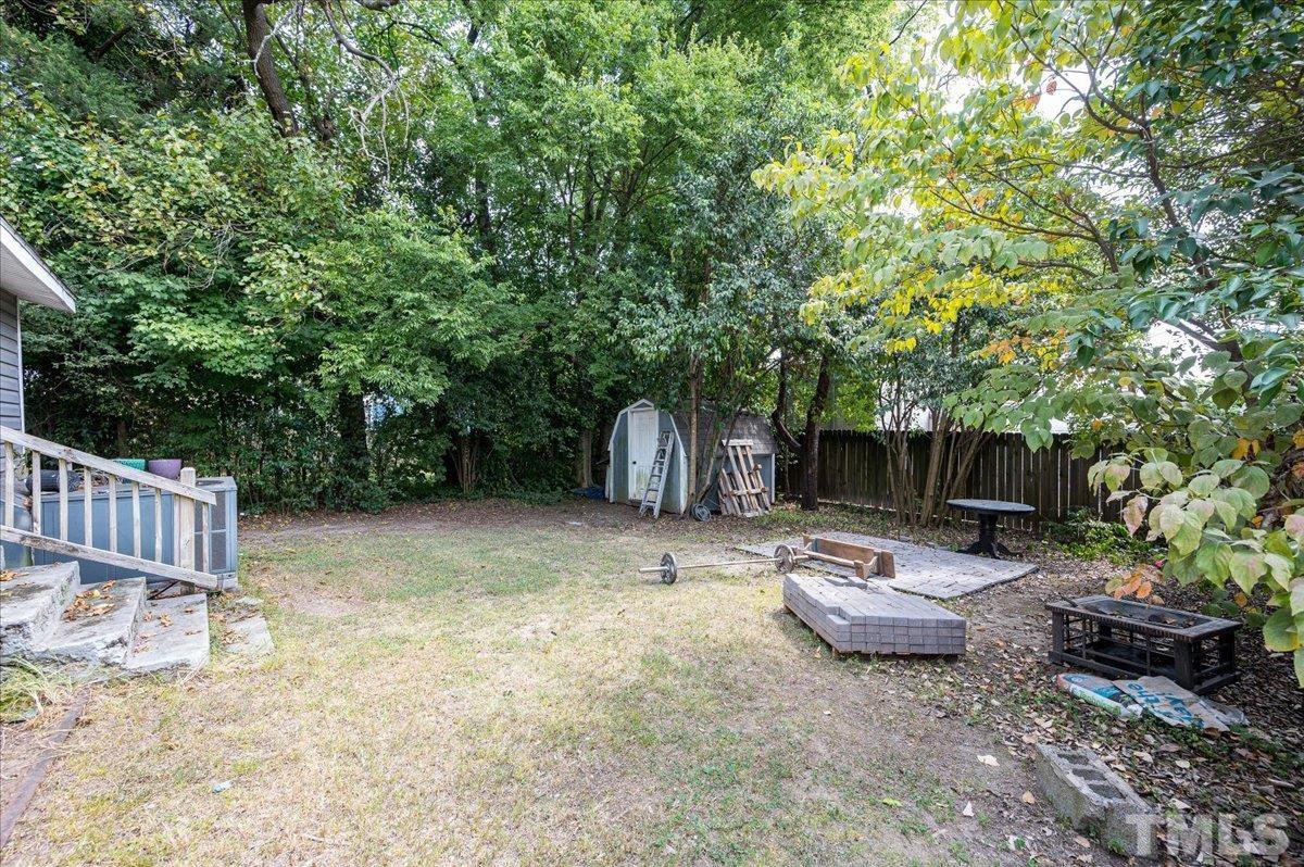 302 Georgetown Road Raleigh, NC 27608 - Photo 19 of 19 a view of a backyard with table and chairs and a barbeque