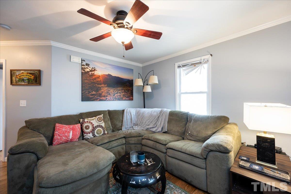 302 Georgetown Road Raleigh, NC 27608 - Photo 3 of 19 a living room with furniture a ceiling fan and a window