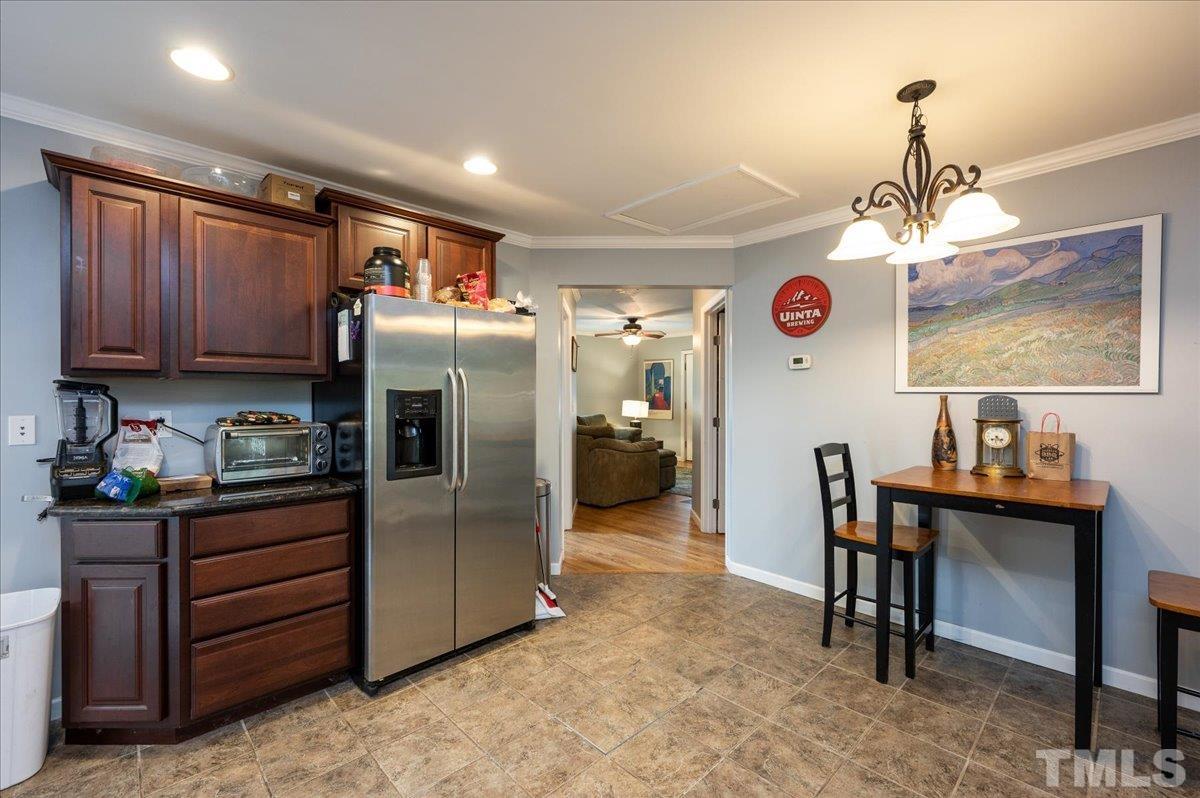 302 Georgetown Road Raleigh, NC 27608 - Photo 6 of 19 a kitchen with granite countertop a table chairs refrigerator and microwave