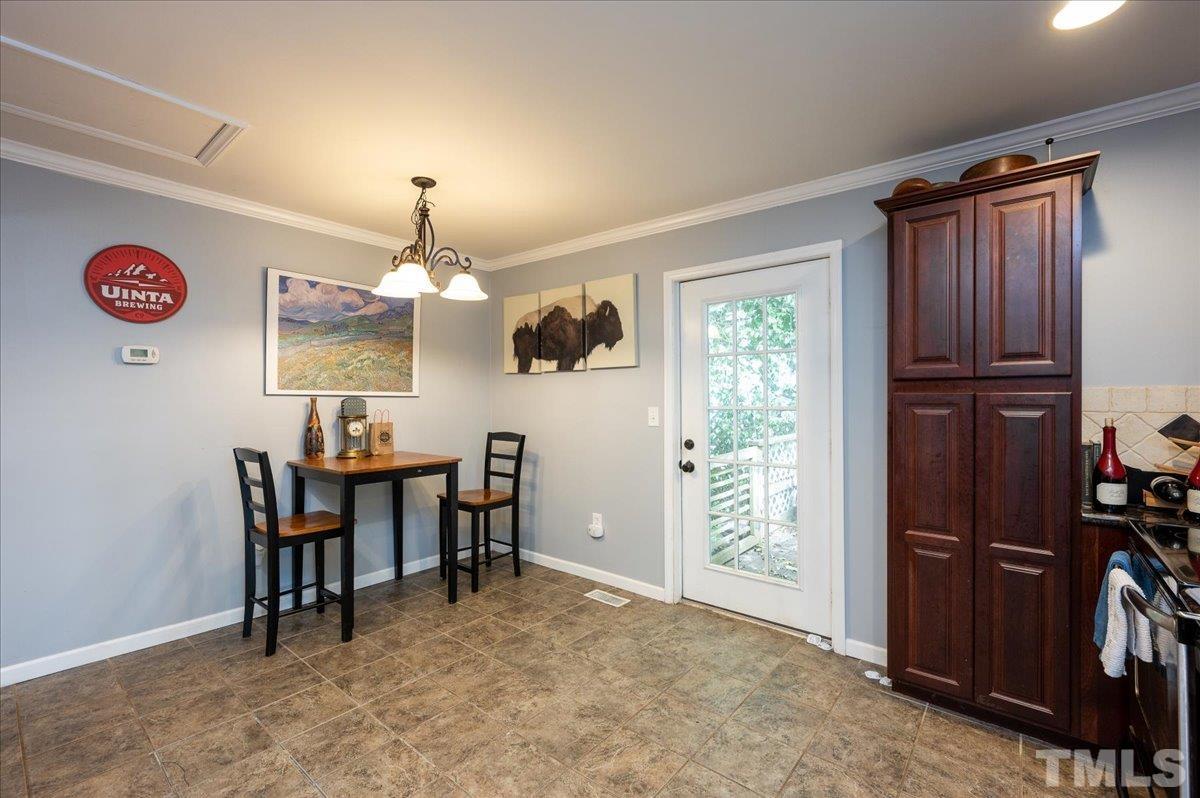 302 Georgetown Road Raleigh, NC 27608 - Photo 9 of 19 a view of a dining room with furniture window and outside view