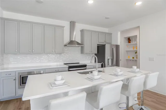 a kitchen with stainless steel appliances sinks a stove and a sink