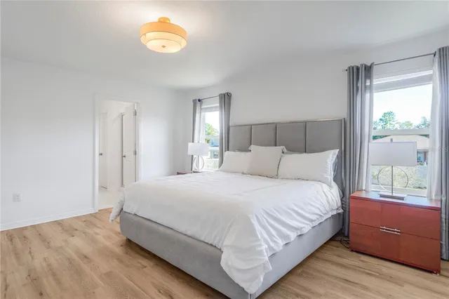 a bedroom with a bed next to a window