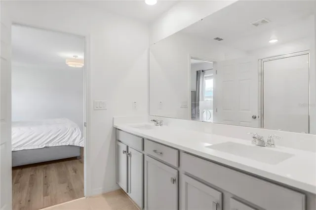 a bedroom with a bed and painting on the wall