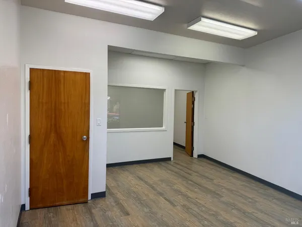 an empty room with wooden floor and closet