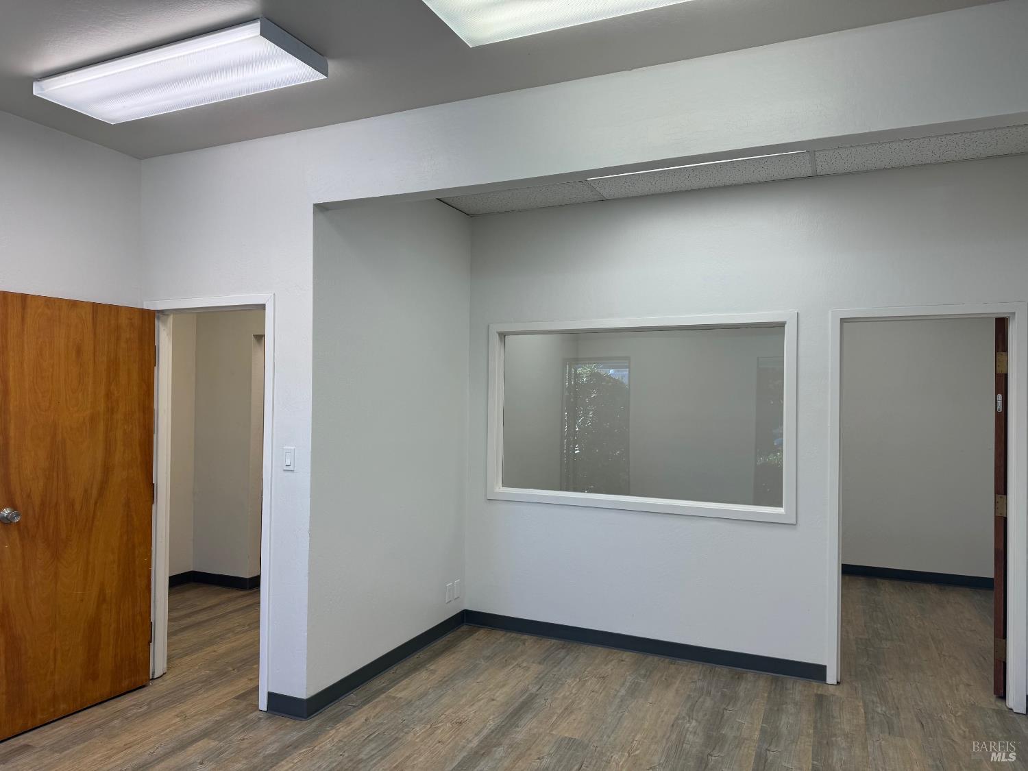 14 Commercial Boulevard, Unit 131 Novato, CA 94949 - Photo 3 of 6 a view of an empty room with wooden floor and a window