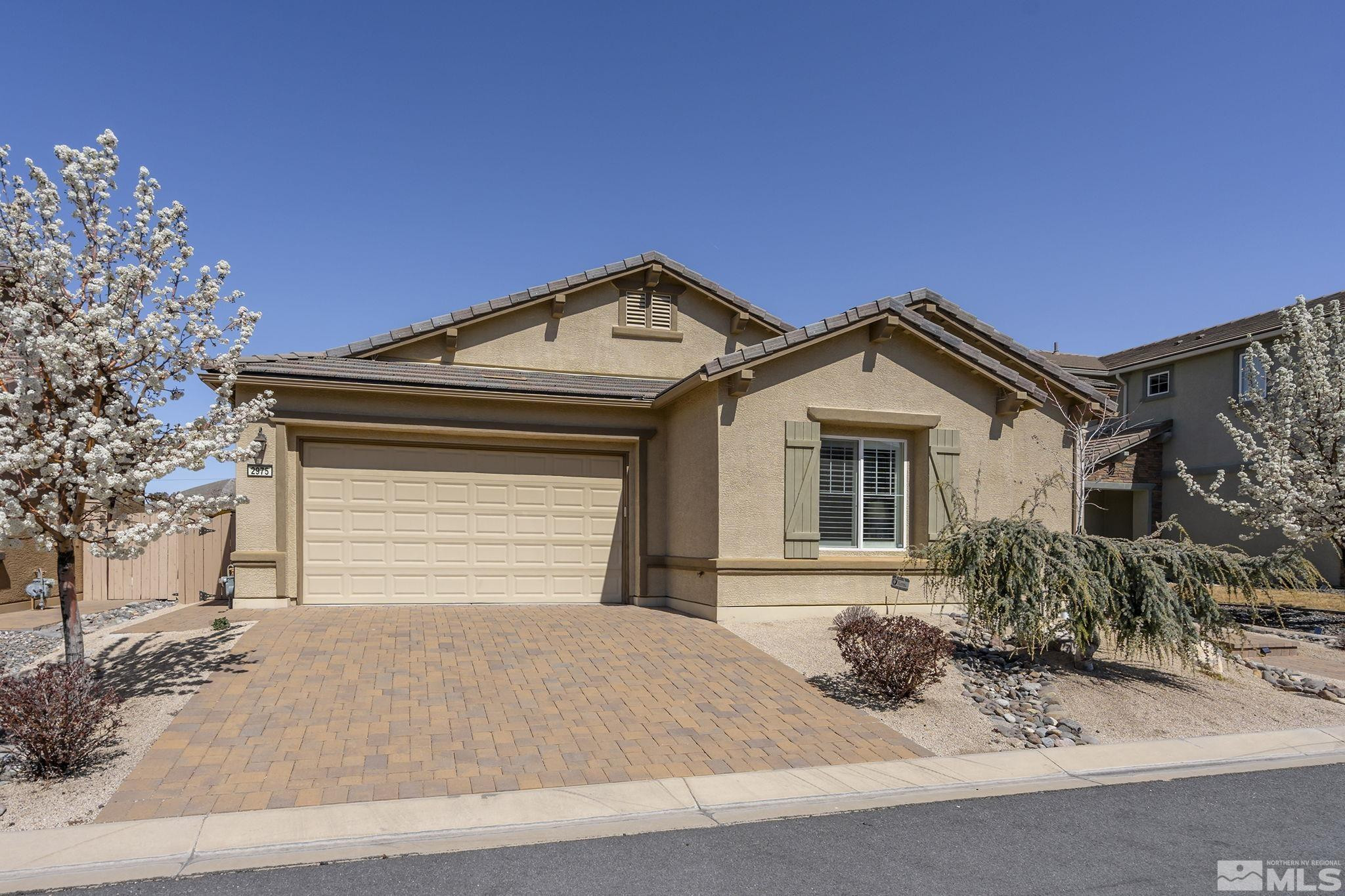 2975 Show Jumper Lane Reno, NV 89521 - Photo 1 of 32 a front view of a house with a yard and garage