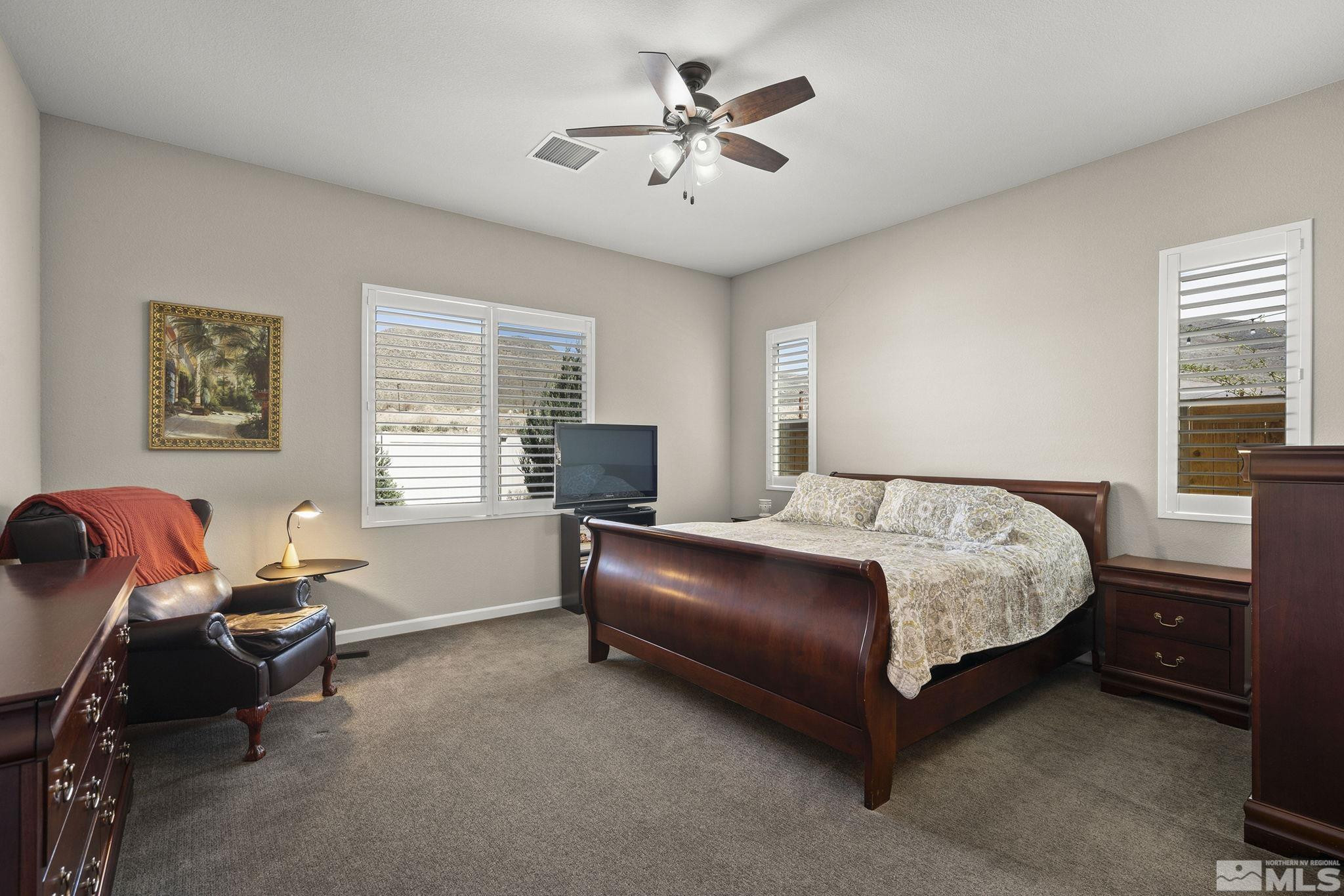 2975 Show Jumper Lane Reno, NV 89521 - Photo 13 of 32 a bedroom with a bed and a chandelier