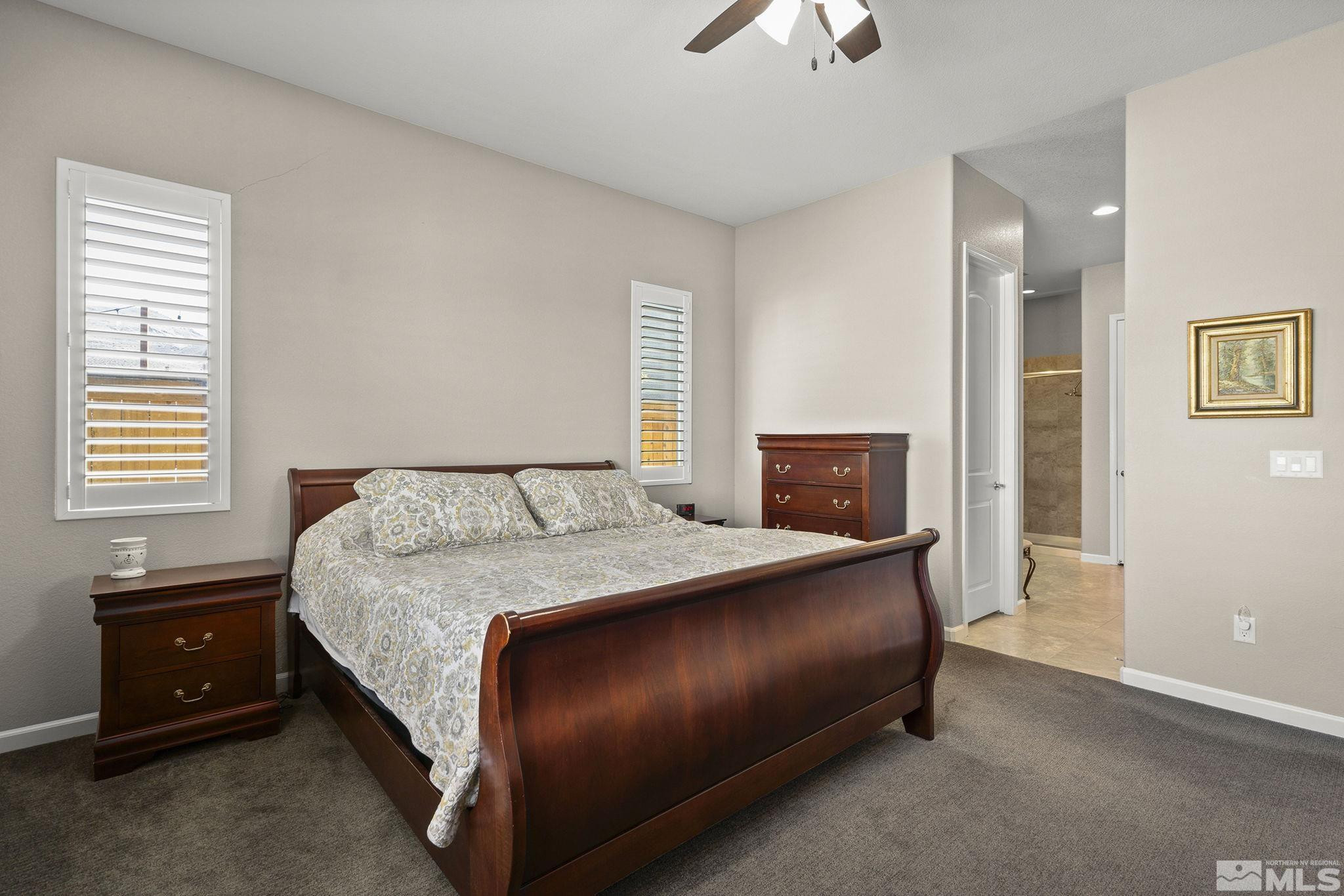 2975 Show Jumper Lane Reno, NV 89521 - Photo 14 of 32 a bedroom with a bed and a lamp