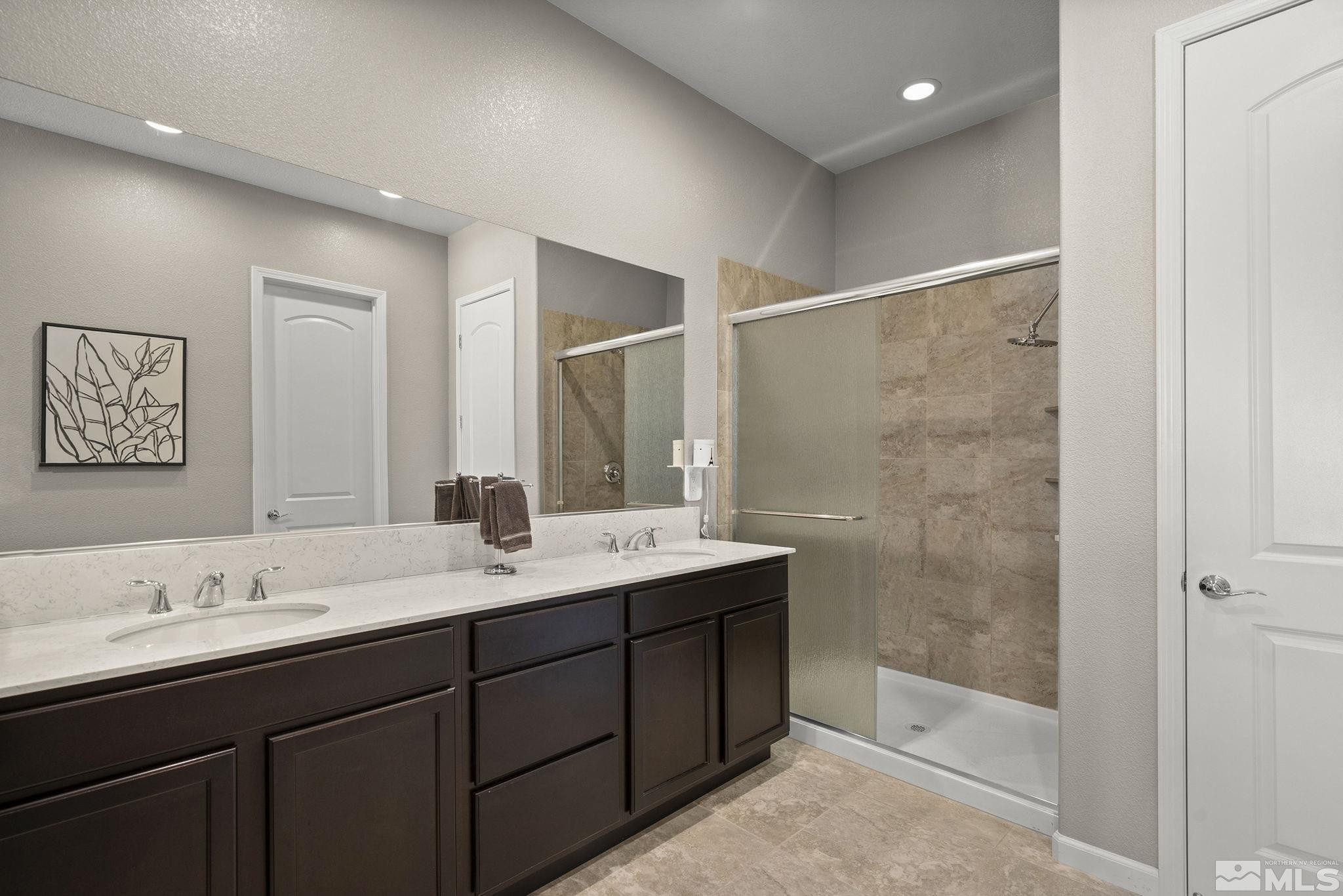 2975 Show Jumper Lane Reno, NV 89521 - Photo 15 of 32 a bathroom with a double vanity sink mirror and shower