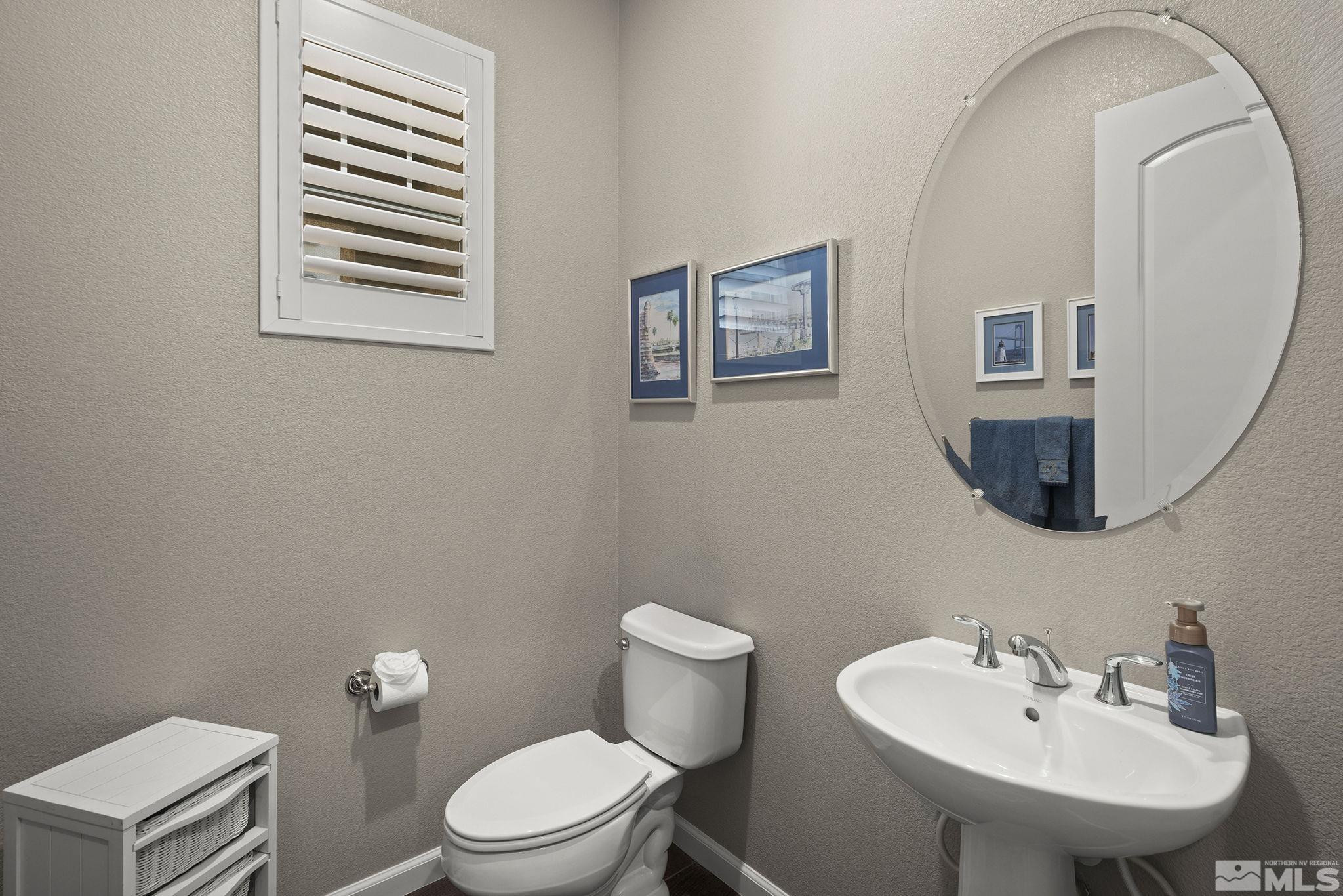 2975 Show Jumper Lane Reno, NV 89521 - Photo 18 of 32 a bathroom with a toilet a sink and mirror