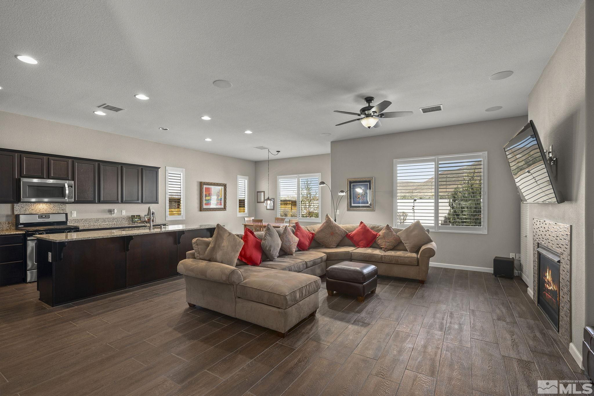 2975 Show Jumper Lane Reno, NV 89521 - Photo 4 of 32 a living room with furniture kitchen view and a fireplace