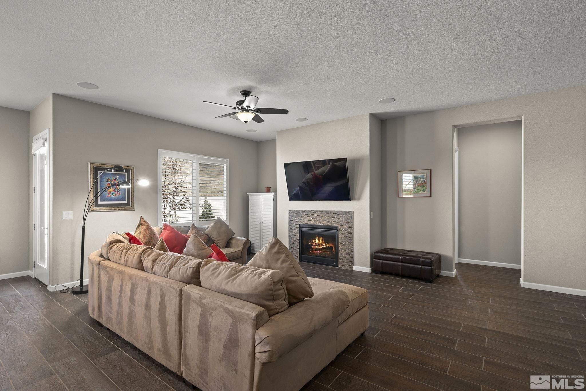 2975 Show Jumper Lane Reno, NV 89521 - Photo 5 of 32 a living room with furniture a fireplace and a flat screen tv