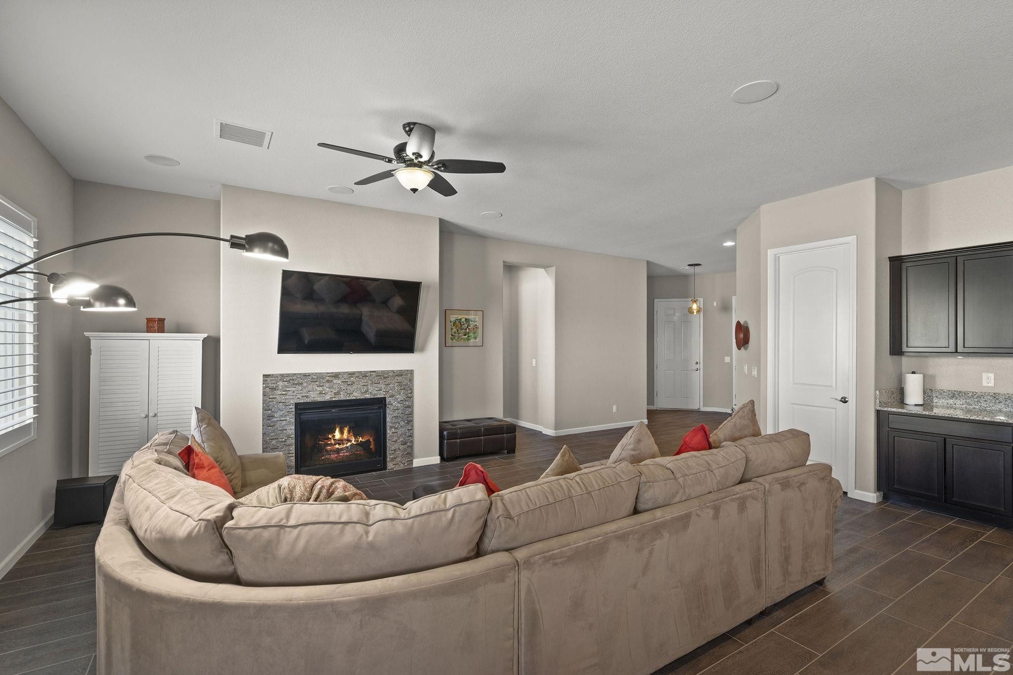 2975 Show Jumper Lane Reno, NV 89521 - Photo 6 of 32 a living room with furniture fireplace and flat screen tv