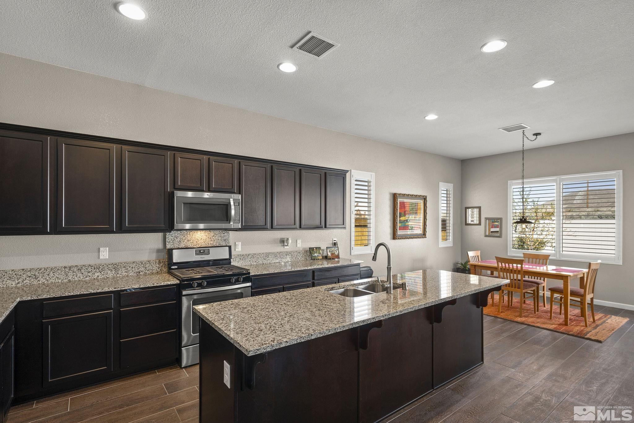 2975 Show Jumper Lane Reno, NV 89521 - Photo 9 of 32 a kitchen with a sink stove and microwave