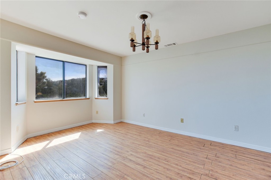 2929 Snow Line Drive Pinon Hills, CA 92372 - Photo 17 of 67 a view of empty room with wooden floor and fan