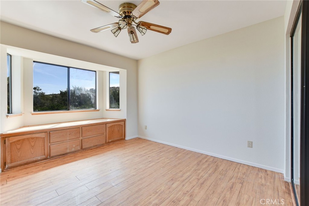 2929 Snow Line Drive Pinon Hills, CA 92372 - Photo 26 of 67 a view of an empty room with a window and wooden floor