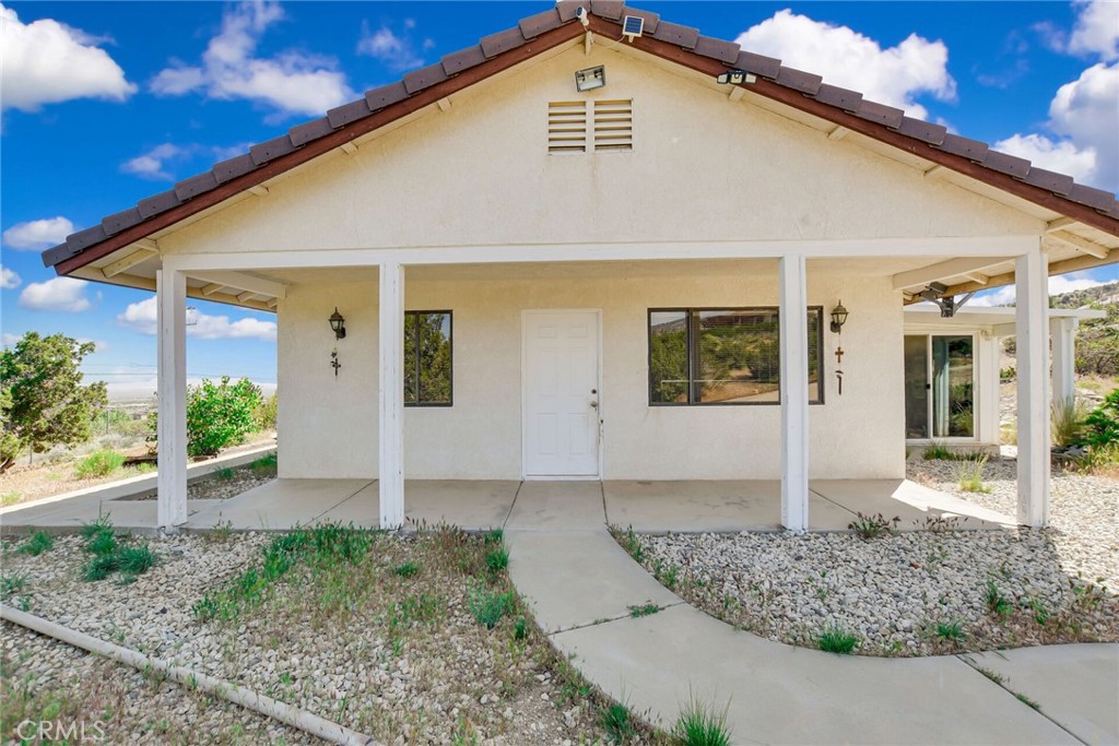 2929 Snow Line Drive Pinon Hills, CA 92372 - Photo 40 of 67 a front view of a house with garden