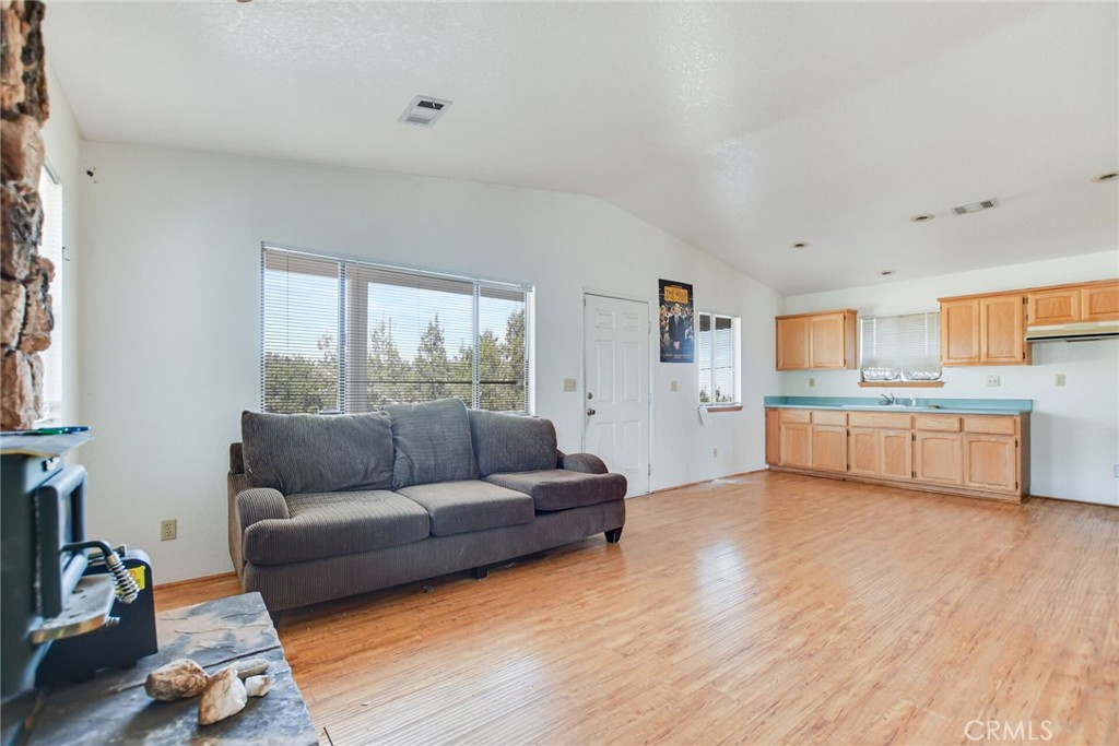2929 Snow Line Drive Pinon Hills, CA 92372 - Photo 44 of 67 a living room with furniture and kitchen view