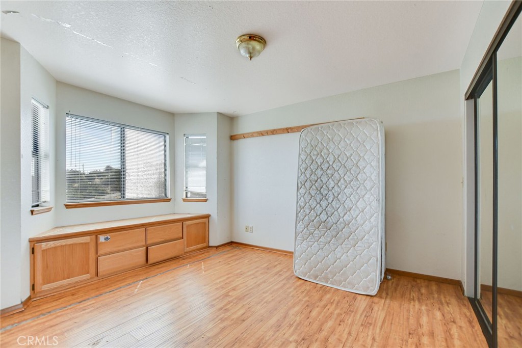 2929 Snow Line Drive Pinon Hills, CA 92372 - Photo 48 of 67 a view of an empty room with wooden floor and a window