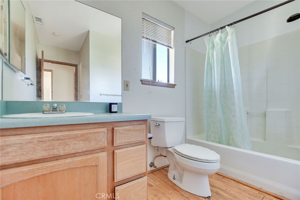 2929 Snow Line Drive Pinon Hills, CA 92372 - Photo 49 of 67 a bathroom with a toilet a sink and a mirror