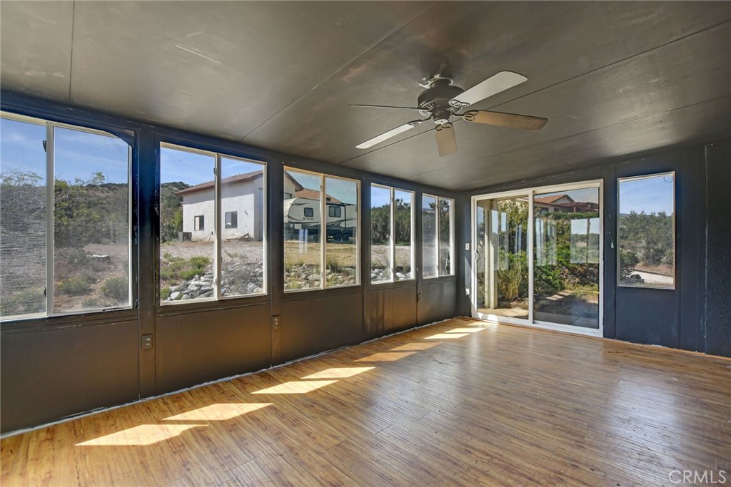 2929 Snow Line Drive Pinon Hills, CA 92372 - Photo 52 of 67 a view of an empty room with wooden floor and a window