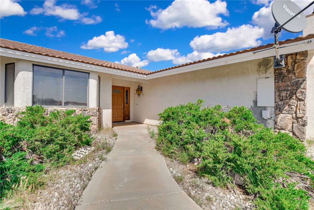 2929 Snow Line Drive Pinon Hills, CA 92372 - Photo 8 of 67 a view of a house with a flower garden