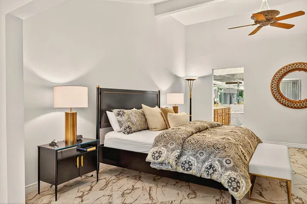 a bedroom with a bed and a chandelier