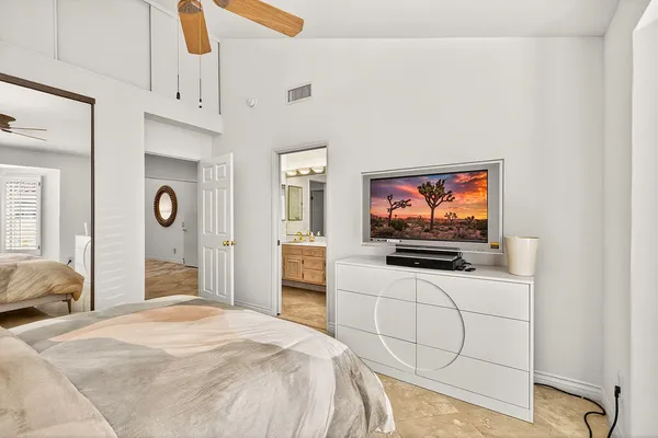 a bedroom with furniture and a flat screen tv