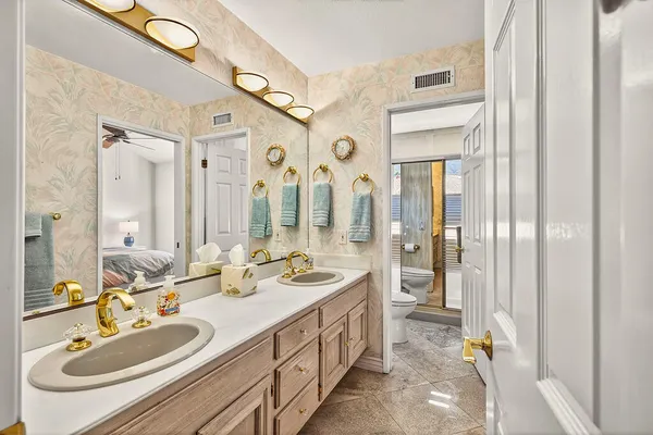 a spacious bathroom with a double vanity sink mirror and double