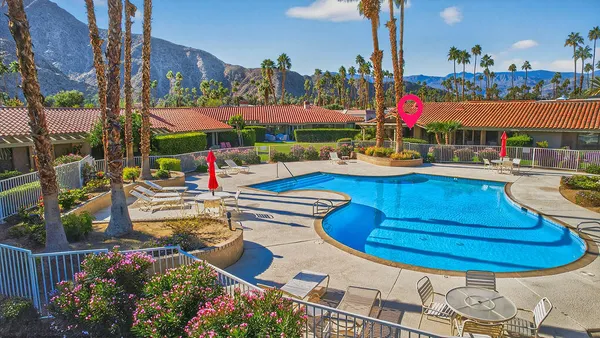 a view of a swimming pool with outdoor seating