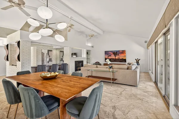 a view of a dining room with furniture and a chandelier