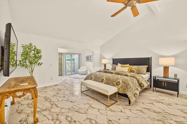a bedroom with a bed and a potted plant