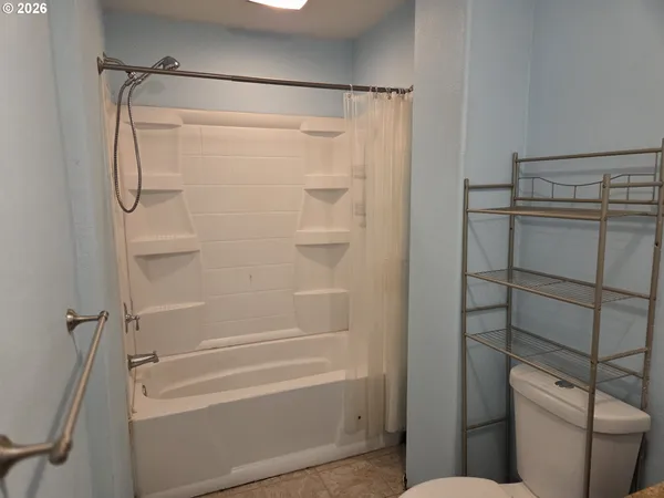 a bathroom with a shower and a toilet