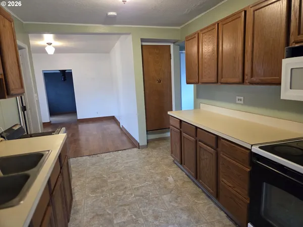 a kitchen with a sink and a refrigerator