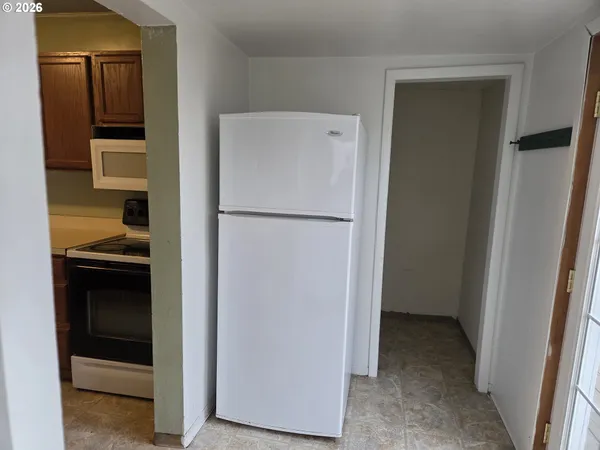 a view of a kitchen from the hallway