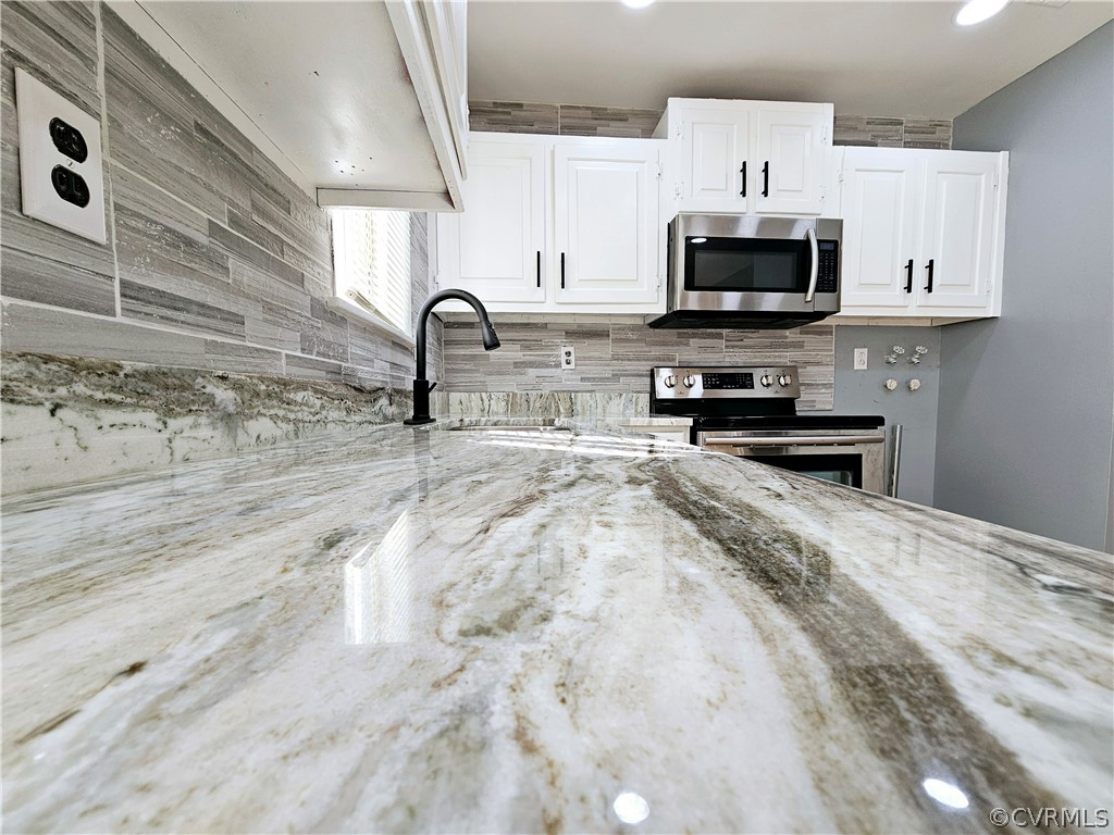3501 Luckylee Crescent Richmond, VA 23234 - Photo 6 of 16 a kitchen with stainless steel appliances granite countertop a sink a stove and microwave
