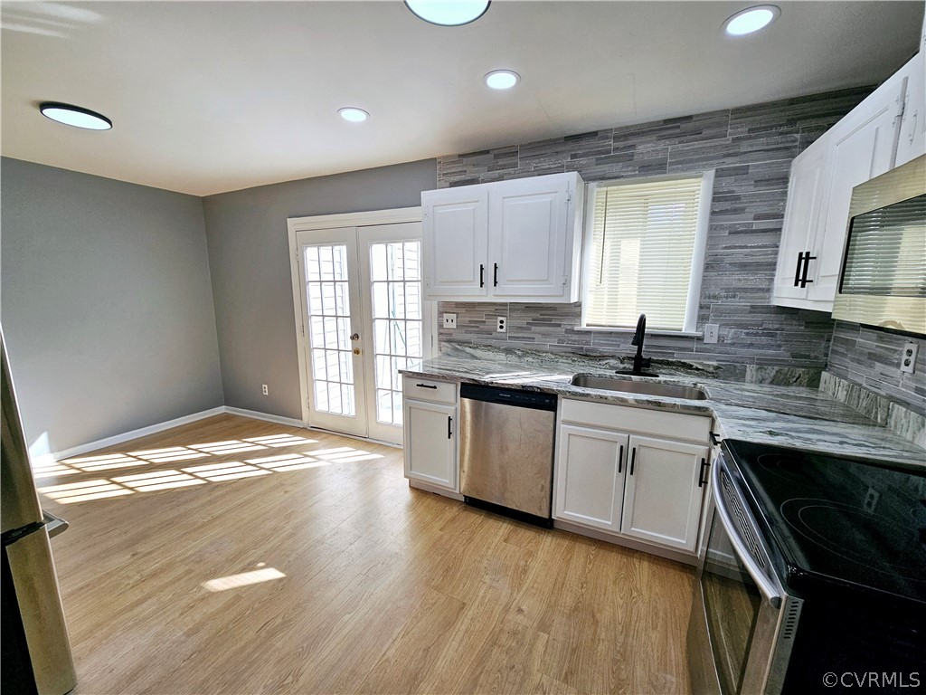 3501 Luckylee Crescent Richmond, VA 23234 - Photo 8 of 16 a kitchen with granite countertop a sink stove and cabinets
