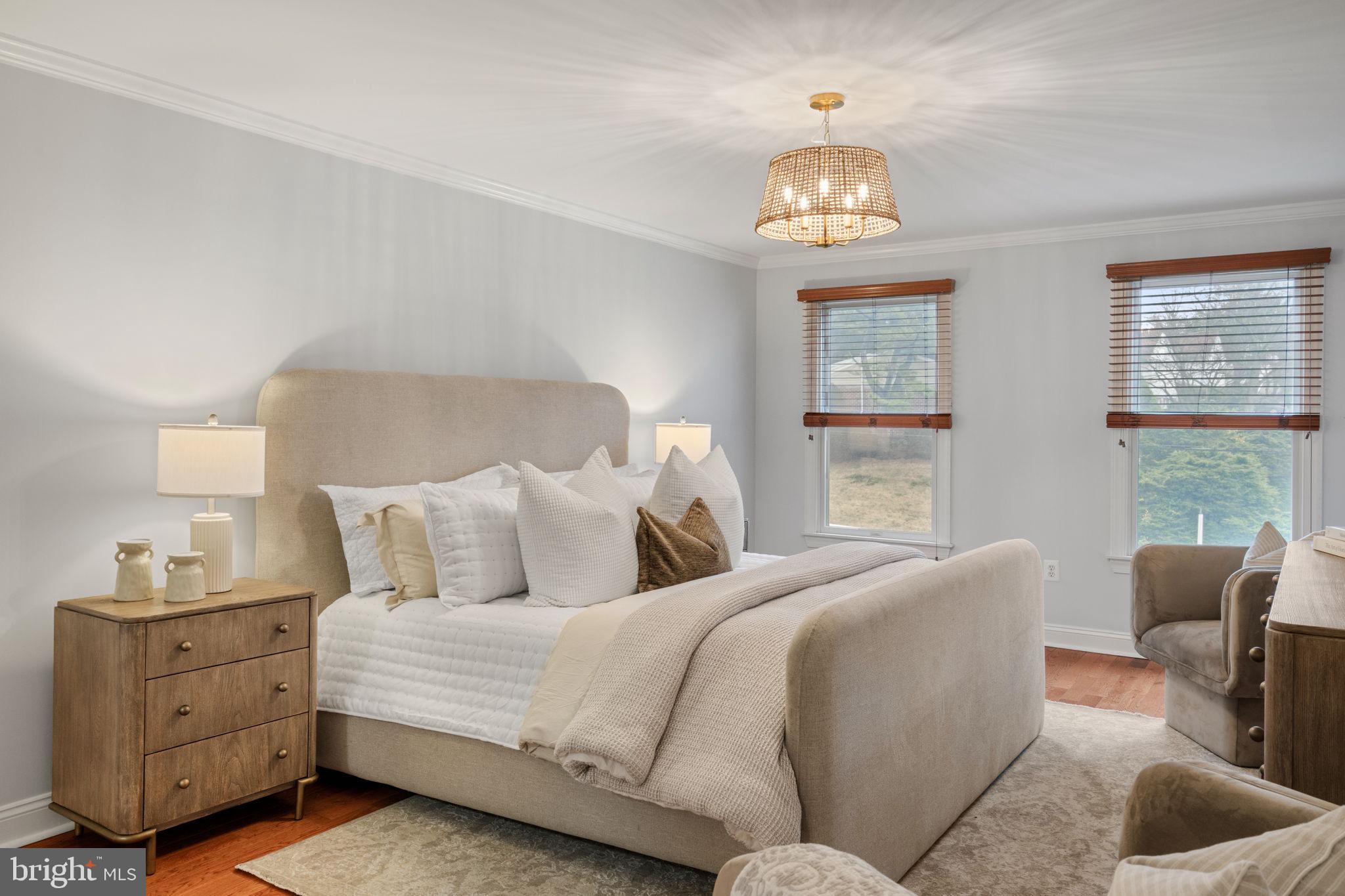 1723 Powder Mill Lane Wynnewood, PA 19096 - Photo 28 of 46 a bedroom with a bed and a chandelier