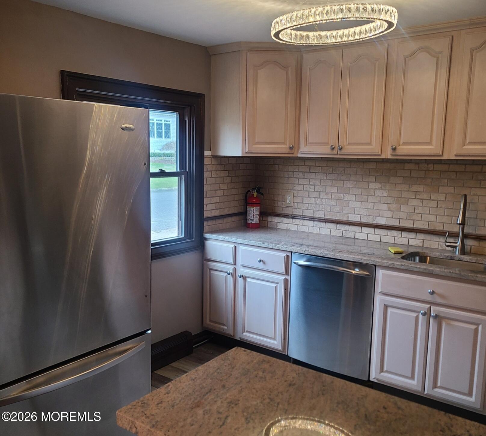 634 Point Avenue Brick, NJ 08724 - Photo 11 of 15 a kitchen with stainless steel appliances granite countertop a refrigerator sink and cabinets
